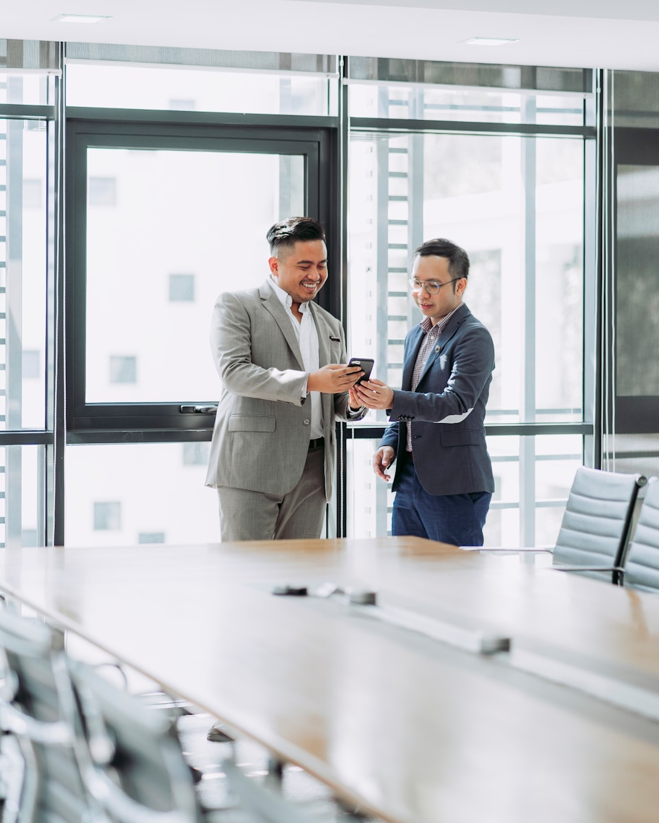Photo by Muhammad Faiz Zulkeflee two men shaking hands in a conference room
